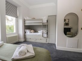 A bedroom with a bunk bed and double bed at Brettargh Holt Mansion 32 near Levens