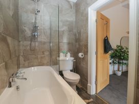 A bathroom featuring a bathtub and toilet at Brettargh Holt Mansion 32 near Levens
