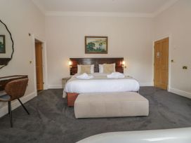 A bedroom with a bed and a desk at Brettargh Holt Mansion 32 near Levens