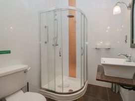 A bathroom with a shower, toilet, and sink at Brettargh Holt Mansion 32 near Levens