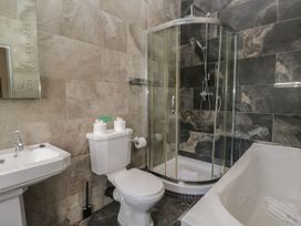 A bathroom with a sink, toilet, shower, and bathtub at Brettargh Holt Mansion 32 near Levens