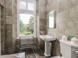 A bathroom with a toilet and basin at Brettargh Holt Mansion 32 near Levens