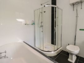A bathroom with a shower enclosure, bathtub, and toilet at Brettargh Holt Mansion 32 near Levens