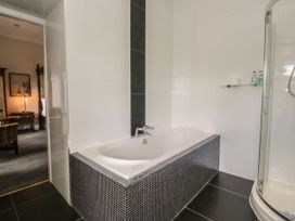 A bathroom with a bathtub and shower at Brettargh Holt Mansion 32 near Levens