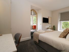 A bedroom with a bed and desk at Brettargh Holt Mansion 32 near Levens