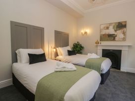 A bedroom with two beds and a fireplace at Brettargh Holt Mansion 32 near Levens