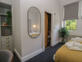 A bedroom with a bed and a wall mirror at Brettargh Holt Mansion 32 near Levens