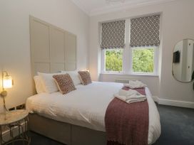 A bedroom with a bed and two windows at Brettargh Holt Mansion 32 near Levens