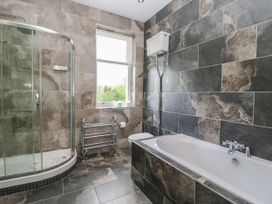 A bathroom with a shower, bathtub, and toilet at Brettargh Holt Mansion 32 near Levens