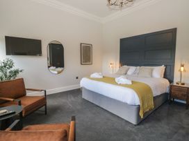 A bedroom with a bed and television at Brettargh Holt Mansion 32 near Levens