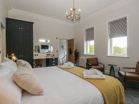 A bedroom with a bed and chairs at Brettargh Holt Mansion 32 near Levens