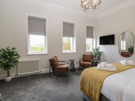 A bedroom with a bed and seating area at Brettargh Holt Mansion 32 near Levens