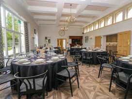 A dining room set for a meal with tables and chairs at Brettargh Holt Mansion 32 near Levens