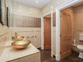 A bathroom with sinks and toilet at Brettargh Holt Mansion 32 near Levens