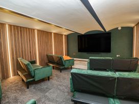 A home theater with sofas and a television at Brettargh Holt Mansion 32 near Levens