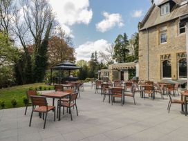 An outdoor seating area with tables and chairs at Brettargh Holt Mansion 32 near Levens