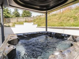 A hot tub with water in an outdoor area at Brynseion Uchaf near Aberystwyth