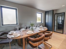 A dining room with a table set for a meal at Brynseion Uchaf near Aberystwyth