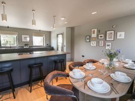 A kitchen with a dining area and bar seating at Brynseion Uchaf near Aberystwyth