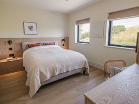 A bedroom with a bed and a desk at Brynseion Uchaf near Aberystwyth