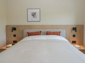A bedroom with a bed and light fixtures at Brynseion Uchaf near Aberystwyth