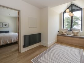 A bedroom with a bed and window seat at Brynseion Uchaf near Aberystwyth
