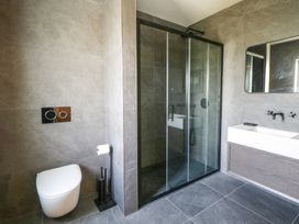 A bathroom with a shower, toilet, and sink at Brynseion Uchaf near Aberystwyth