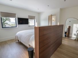 A bedroom with a bed and wooden divider at Brynseion Uchaf near Aberystwyth