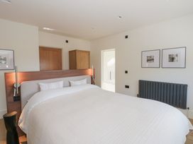 A bedroom with a bed and wardrobe at Brynseion Uchaf near Aberystwyth