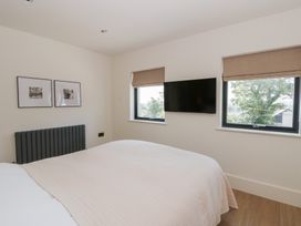 A bedroom with a bed and wall-mounted television at Brynseion Uchaf near Aberystwyth