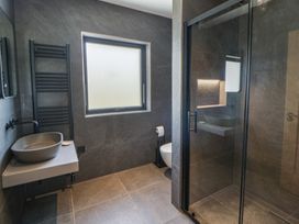 A bathroom with a sink, toilet, and shower at Brynseion Uchaf near Aberystwyth