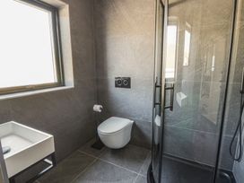 A bathroom featuring a shower, toilet, and hand basin at Brynseion Uchaf near Aberystwyth