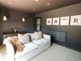 A living room with a sofa and wall art at Brynseion Uchaf near Aberystwyth