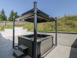 A hot tub with a canopy in an outdoor area at Brynseion Uchaf near Aberystwyth
