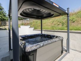 A hot tub with a canopy in a garden at Brynseion Uchaf near Aberystwyth