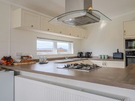 A kitchen with gas stove and appliances at Hazelwood 3 Pinewood Retreat in Rousdon near Lyme Regis