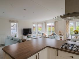 A living room with a television and sofas at Hazelwood 3 in Pinewood Retreat in Rousdon near Lyme Regis