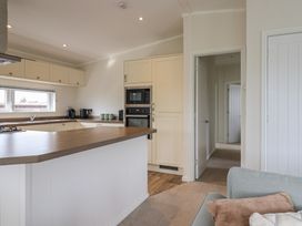 A kitchen with appliances and cabinetry at Hazelwood 3 in Pinewood Retreat in Rousdon near Lyme Regis