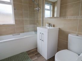 A bathroom with a bathtub, sink, and toilet at Hazelwood 3 Pinewood Retreat in Rousdon near Lyme Regis