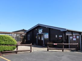 A building exterior with signs at Hazelwood 3 Pinewood Retreat in Rousdon near Lyme Regis