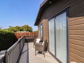 An outdoor area with chairs and decking at Hazelwood 3 Pinewood Retreat in Rousdon near Lyme Regis