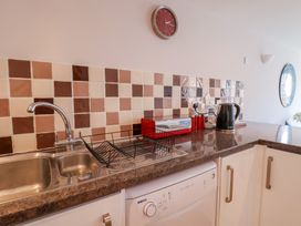 A kitchen with a sink and a dishwasher at Beck House in Weymouth
