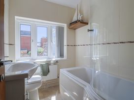 A bathroom with a sink, toilet, and bathtub at Beck House in Weymouth
