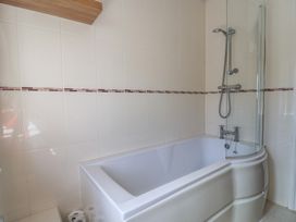 A bathroom with a bathtub and shower at Beck House in Weymouth
