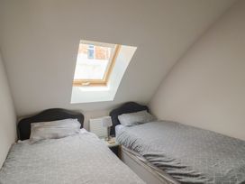 A bedroom with two beds and a window at Beck House in Weymouth