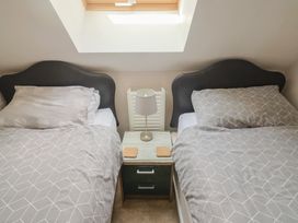 A bedroom with two beds and a nightstand at Beck House in Weymouth