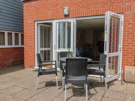 An outdoor area with a table and chairs at Beck House in Weymouth