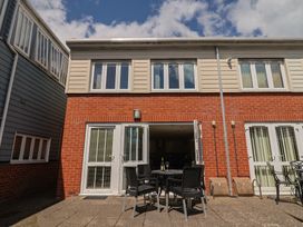 An outdoor area with a table and chairs at Beck House in Weymouth