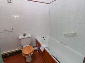 A bathroom with a bathtub, toilet and towel rail at Warbler Cottage, Cowbridge