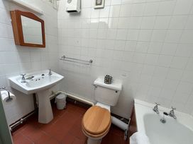 A bathroom with a sink, toilet, and bathtub at Warbler Cottage near Cowbridge